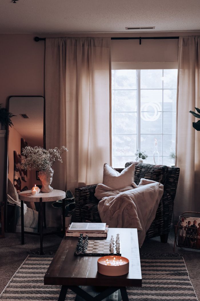 Crafting Captivating Headlines: Your awesome post title goes here A stylish and cozy living room interior with warm lighting, featuring a wicker armchair and decorative elements.