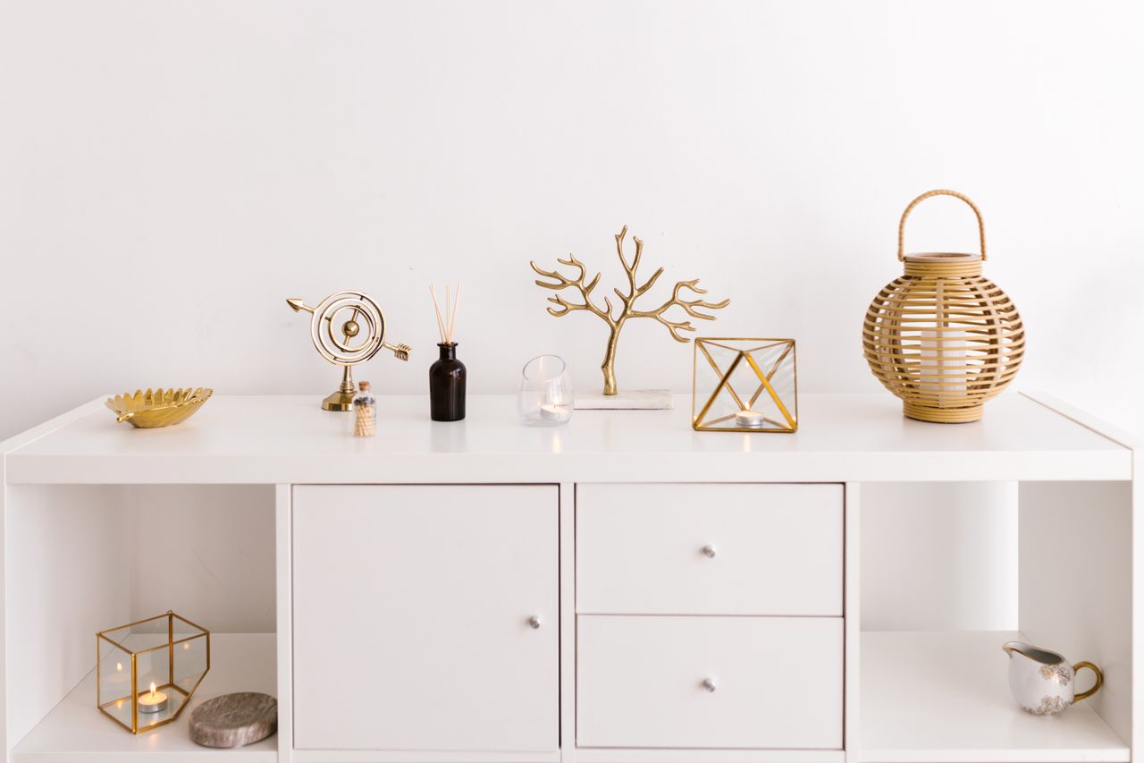 The Art of Drawing Readers In: Your attractive post title goes here Sleek white cabinet with elegant gold decorations on a modern white background